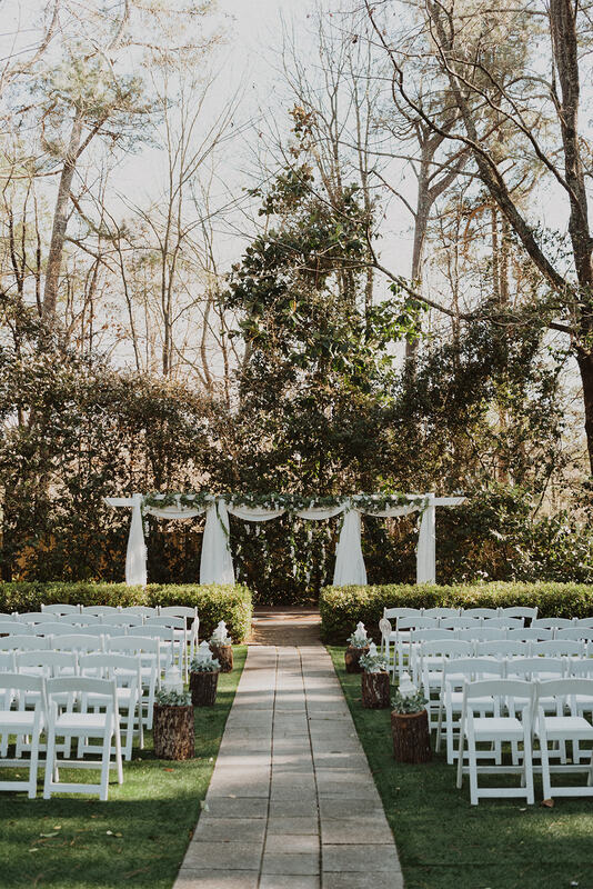 outdoor garden wedding ceremony with greenery and wisteria