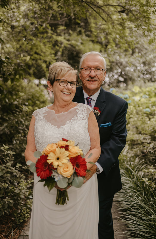 newly married couple in their 70s posing for post-ceremony photos