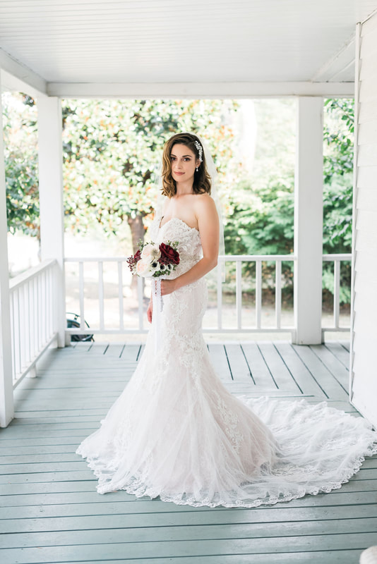 bride in lace strapless dress on farmhouse front porch
