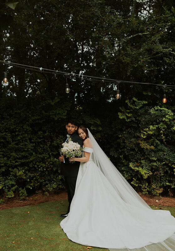 newlyweds posing in garden venue