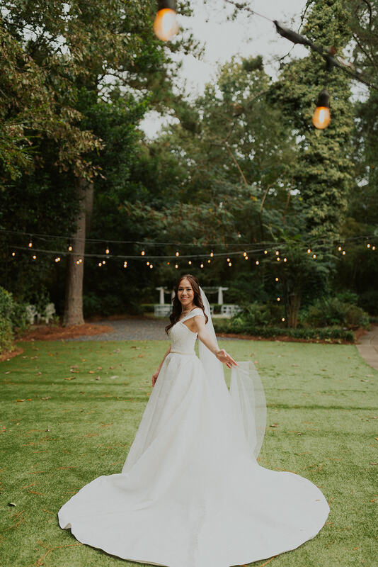 bride twirling dress in garden venue