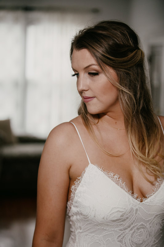 bride wearing lace dress with thin straps in four oaks' bridal suite