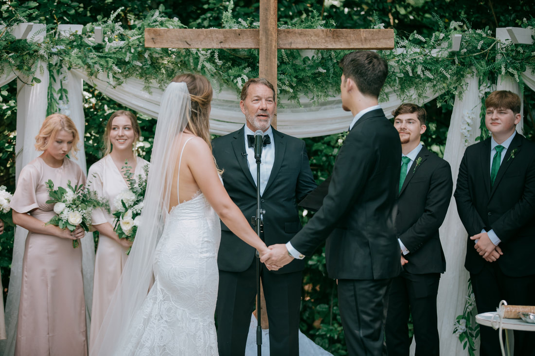 bride and groom at altar looking at officiant during ceremony