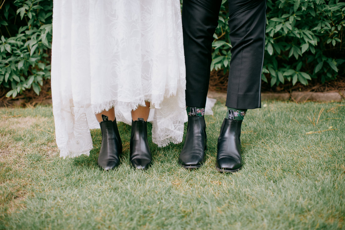 bride and groom wearing matching black boots