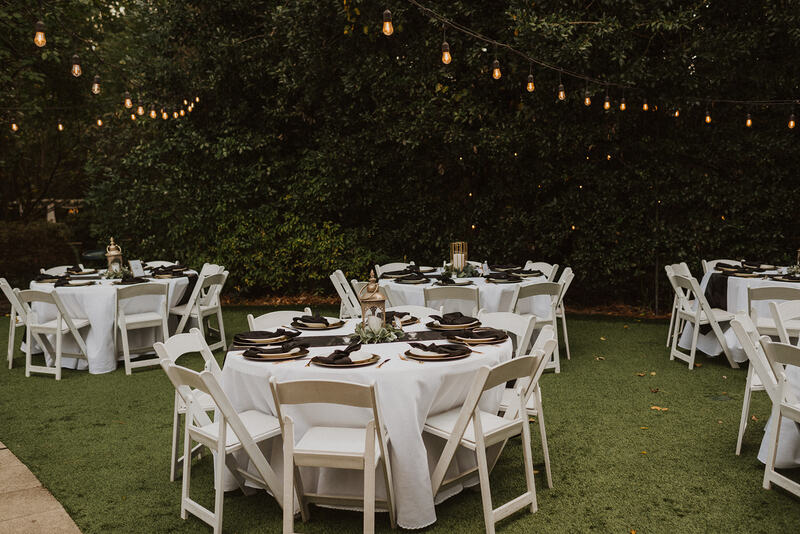 garden wedding reception tables with gold and black decor