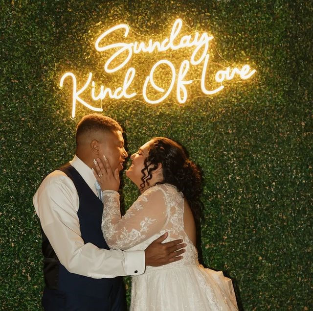 Sunday Kind Of Love LED sign on greenery wall backdrop
