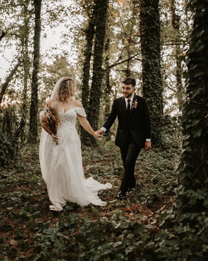 Bride & Groom walking through ivy covered forest