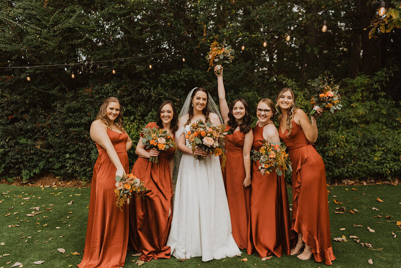 bride posing with fall bridesmaids