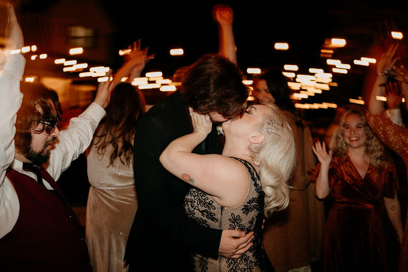 bride and groom kissing on outdoor dance floor