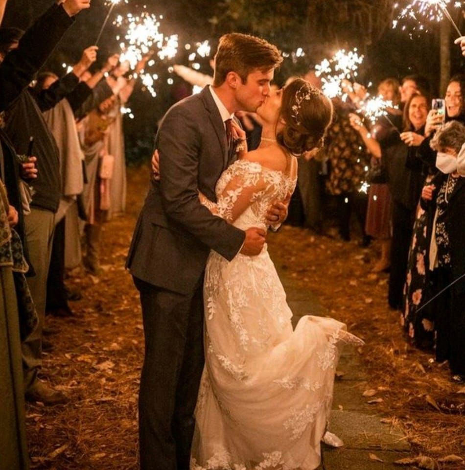 bride and groom kissing during sparkler grand exit