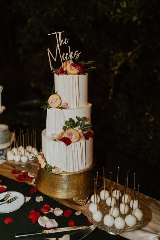 3-tier cake with peaches and florals for decorations