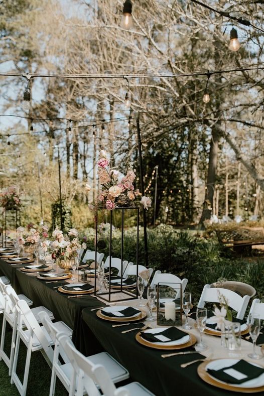 banquet-style reception tables at garden venue with floral decorations