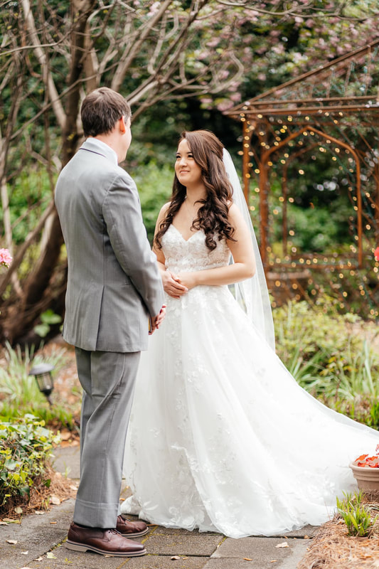bride and groom's first look by outdoor gazebo