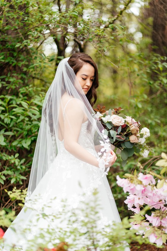 bride posing in garden foliage 