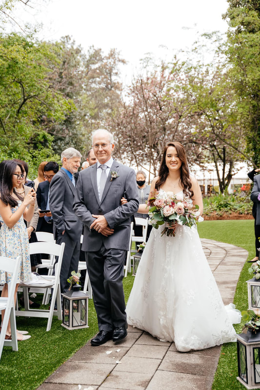 bride walking down aisle at spring outdoor ceremony