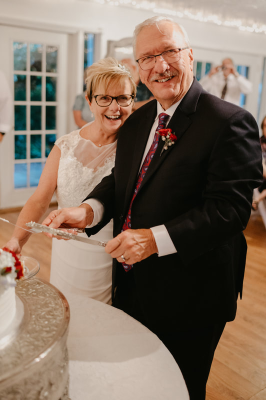 older couple cutting cake together