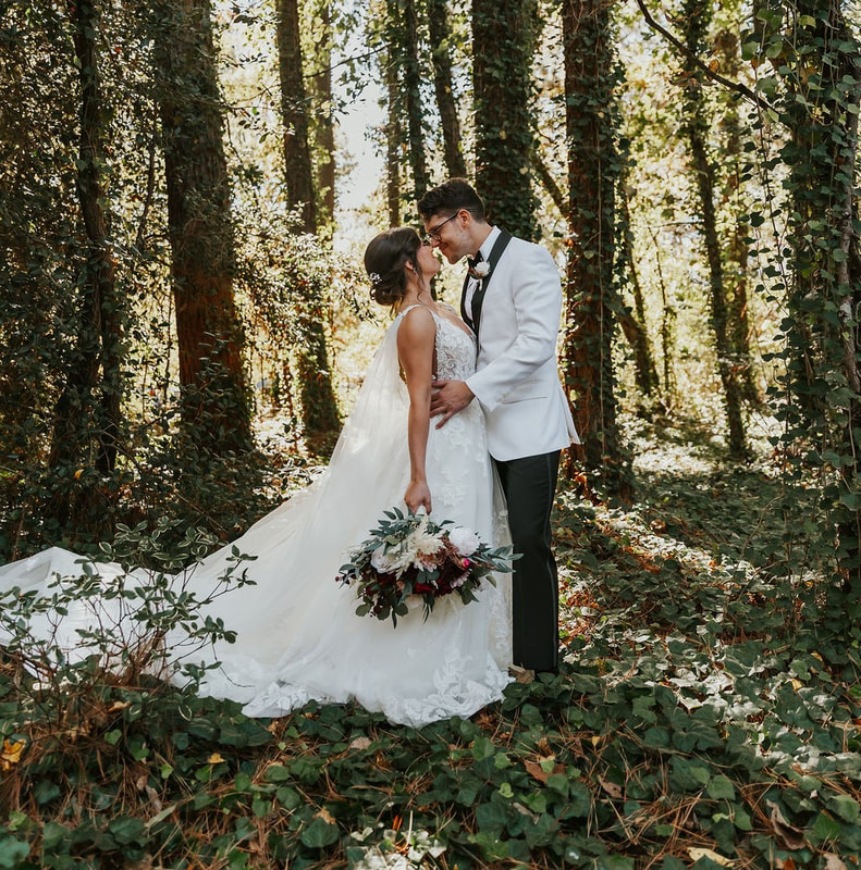 Bride & groom portrait in ivy covered forest