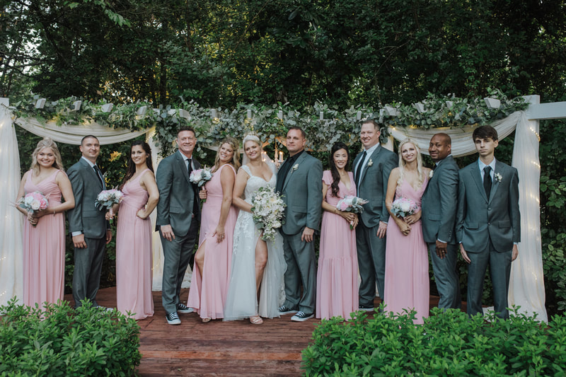 couple with blush and grey wedding party at altar