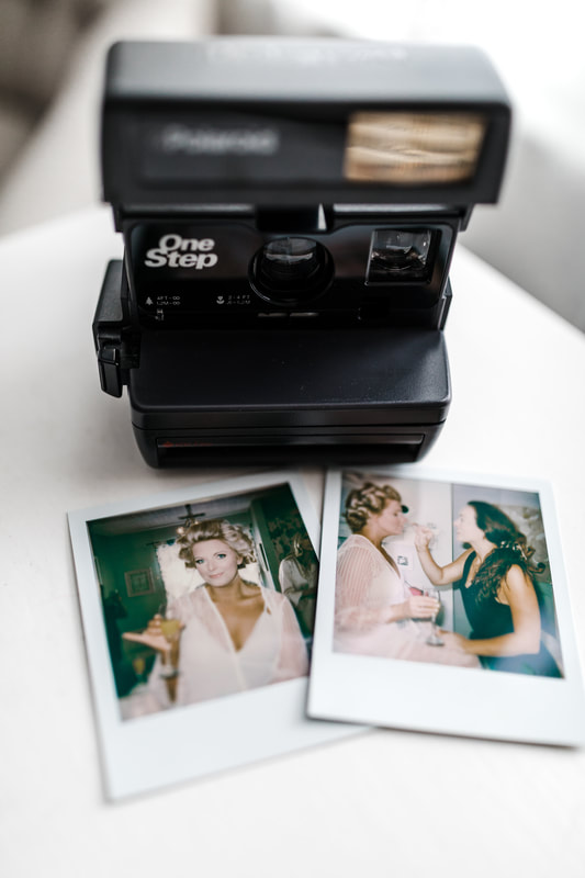camera with polaroid pictures of bride getting ready