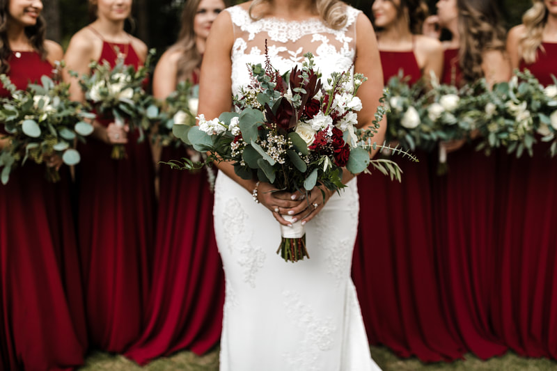 bride's bouquet with eucalyptus and white and burgundy flowers