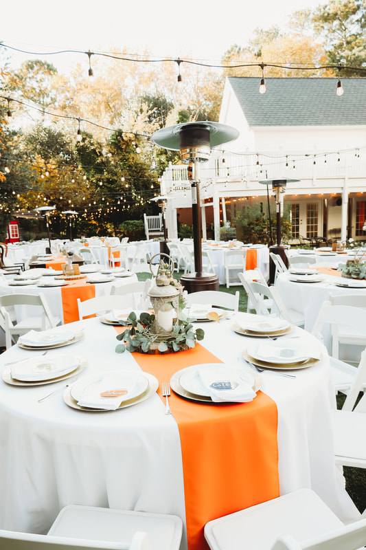 outdoor garden wedding reception with burnt orange details