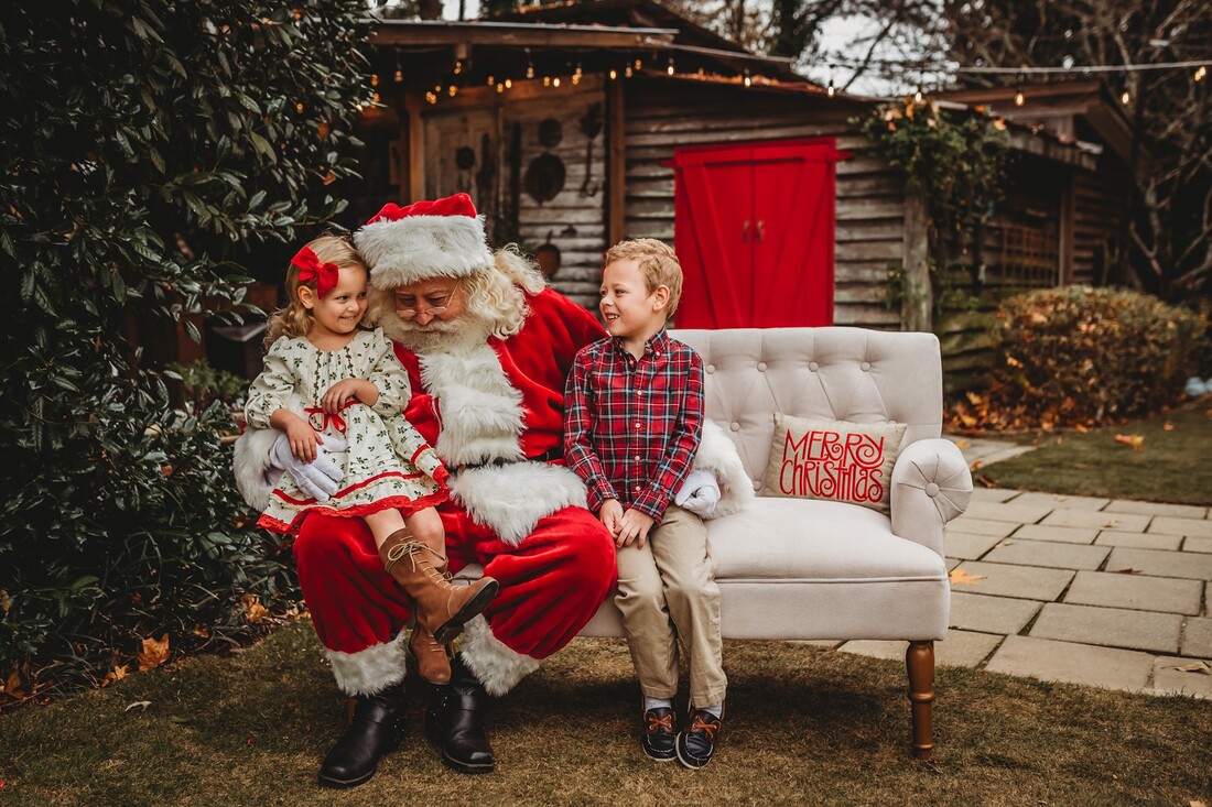 2 kids on chair with Santa at rustic garden event venue