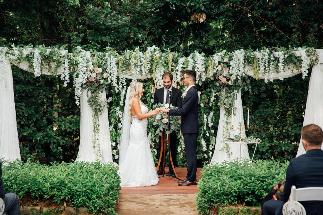 garden ceremony altar with greenery, wisteria, and blush florals