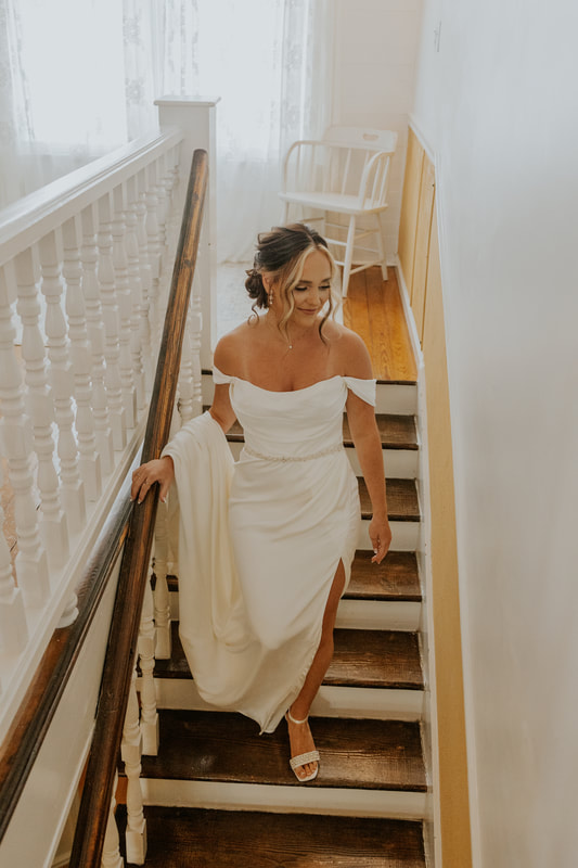 bride walking down farmhouse stairs