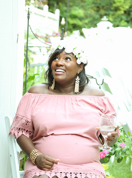 mother-to-be in pink off the shoulder dress and white flower crown