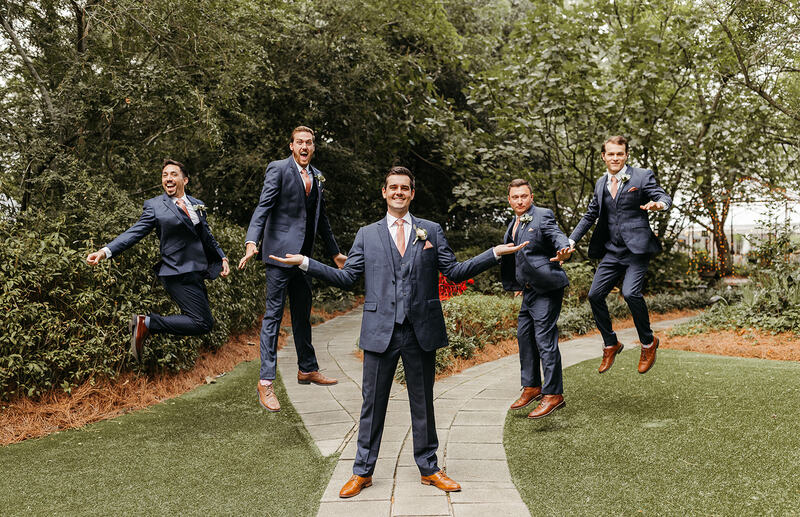 Groomsmen funny photos at garden wedding venue