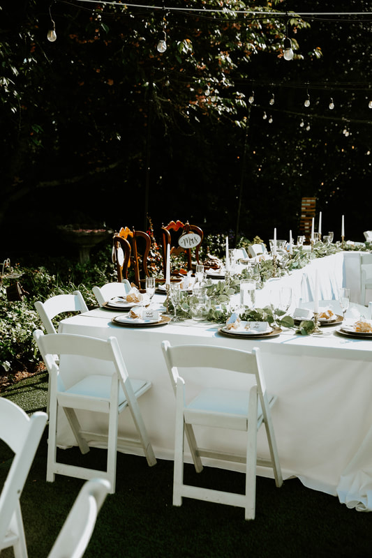 head table with greenery and candles