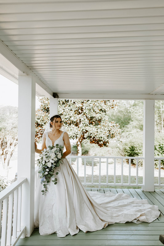 bride posing on farmhouse front porch