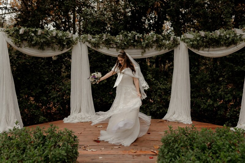bride twirling on outdoor ceremony altar stage