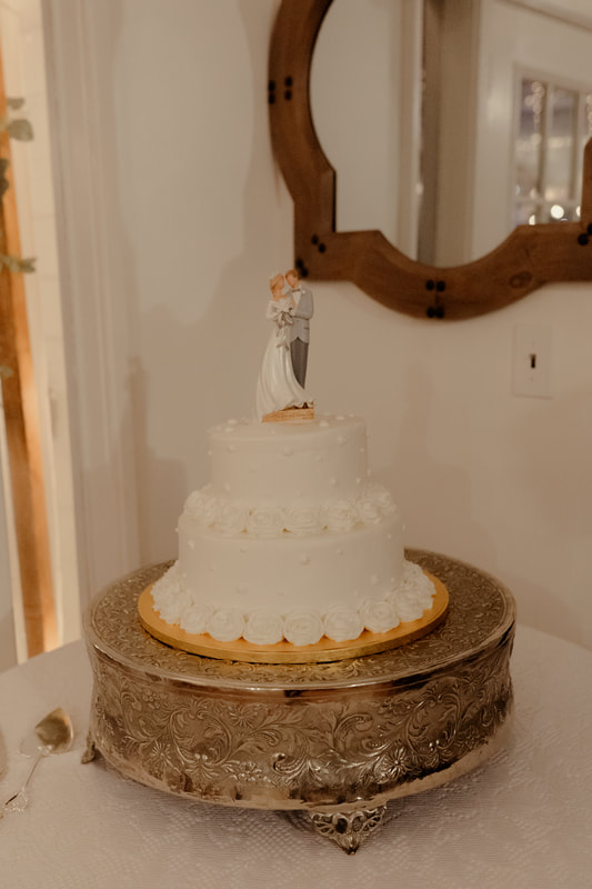 white wedding cake on silver cake stand