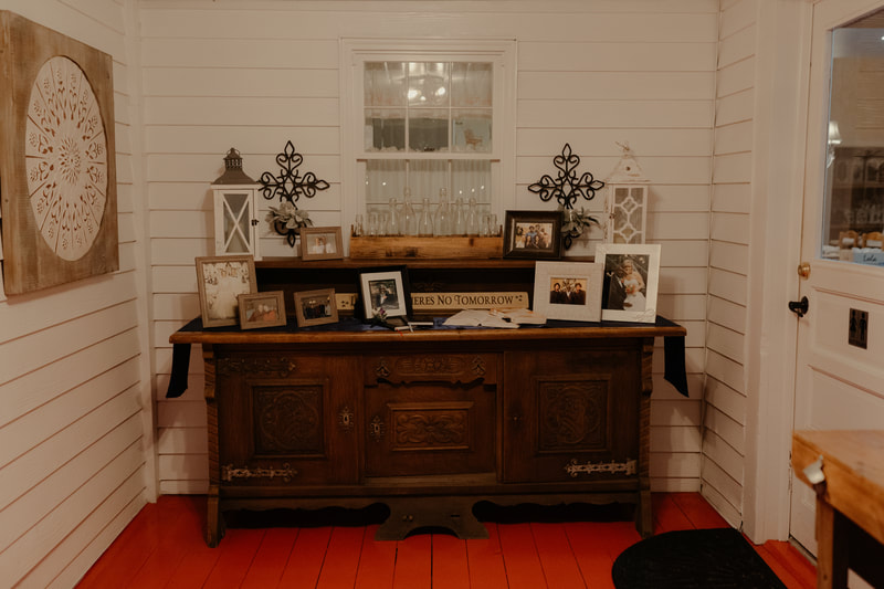 farmhouse memorial table with photos and bible