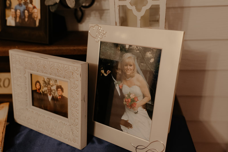 photos on memorial table at farmhouse wedding
