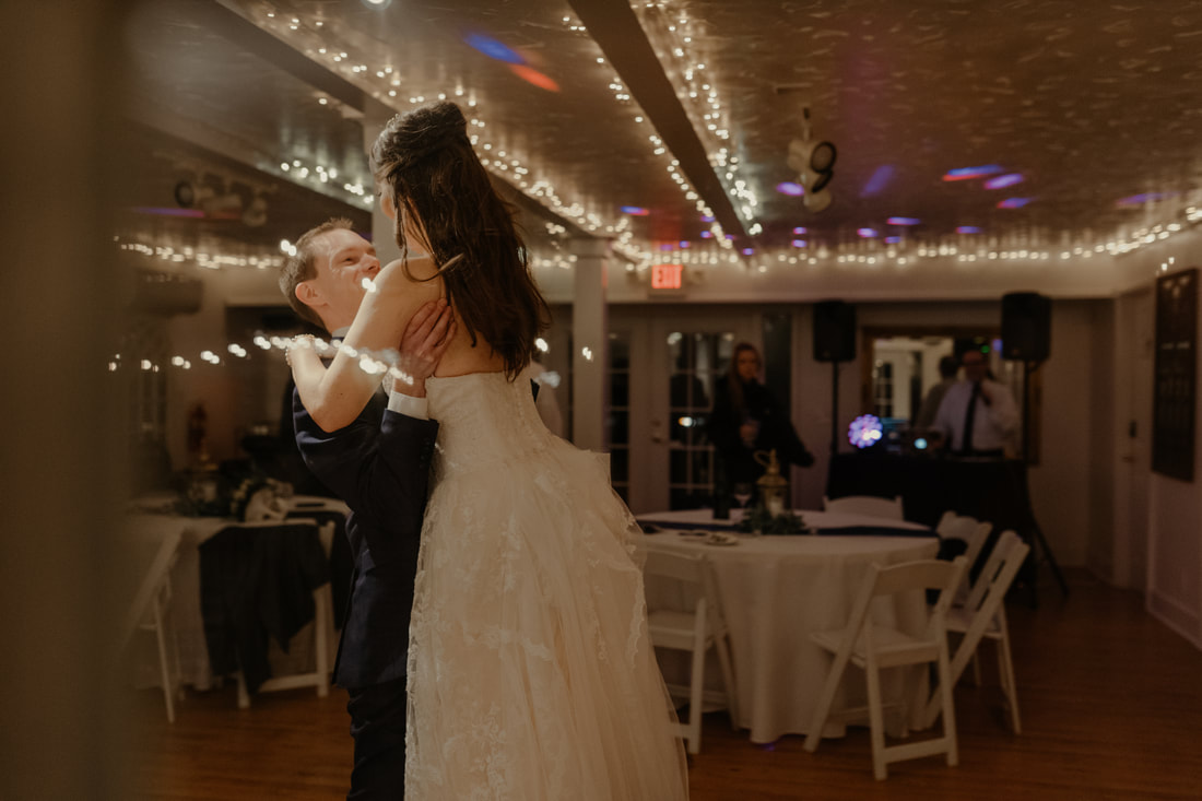 groom lifting bride while dancing