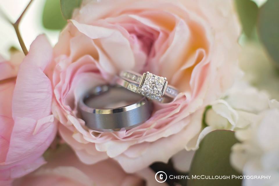 Detail photo of wedding rings in the middle of a pink flower