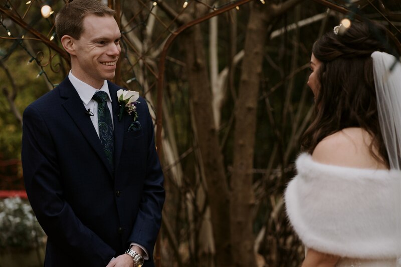 groom smiling at bride during first look