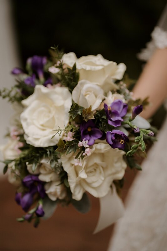 bouquet of white roses and purple flowers