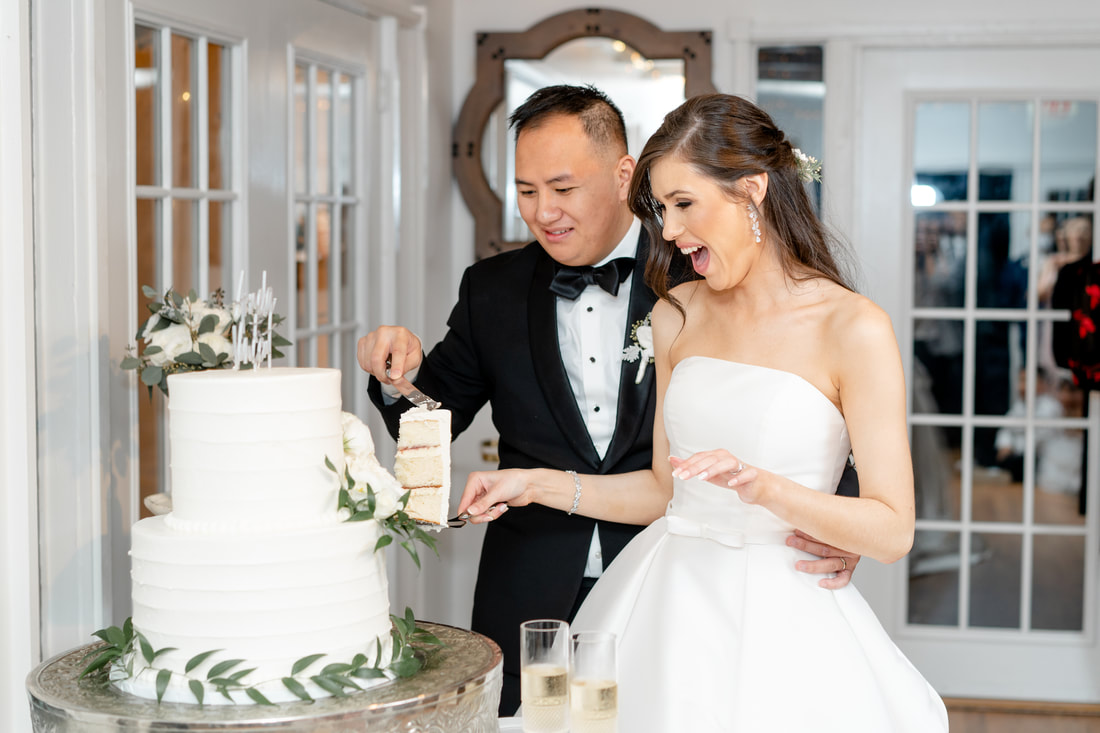 newlyweds cutting cake in carriage house