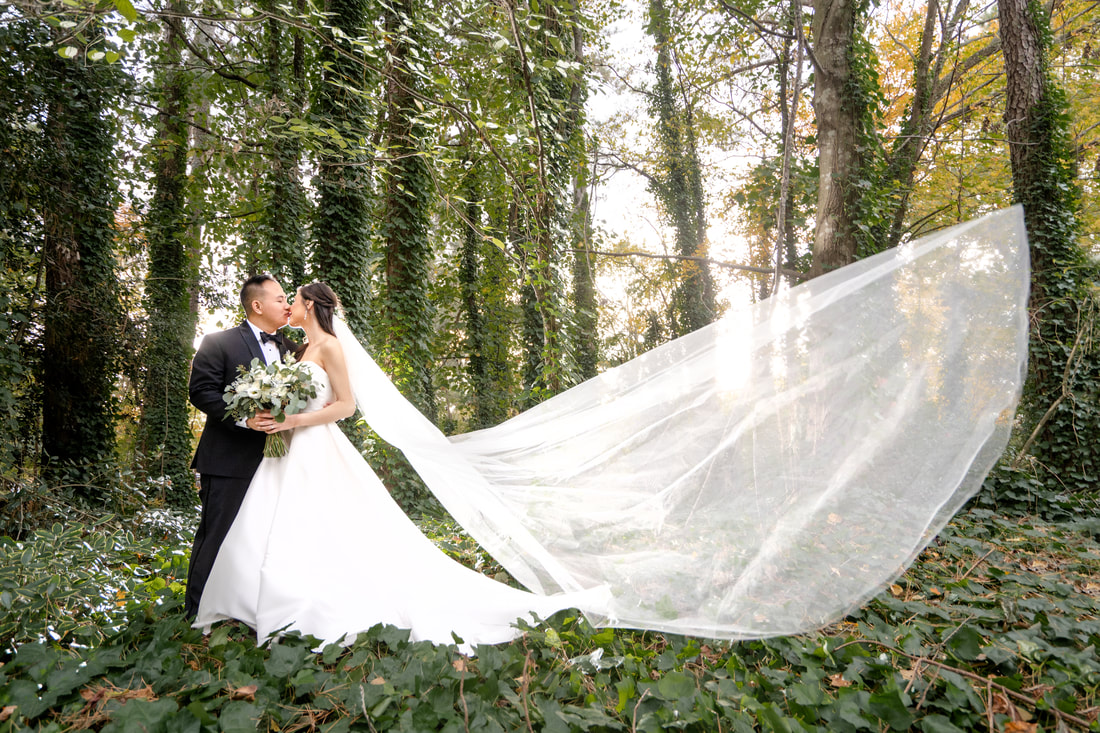 asian couple kissing surrounded by ivy covered trees