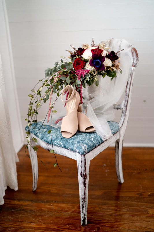 fall bouquet on blue antique chair with heels and veil