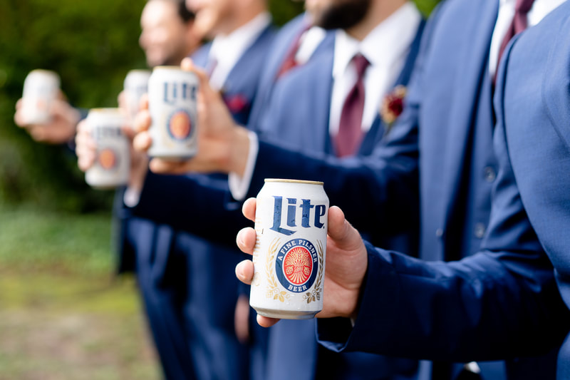 groomsmen holding Miller Lite beer cans