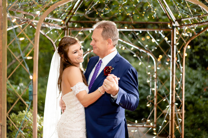 bride dancing with father under gazebo at outdoor fall wedding reception