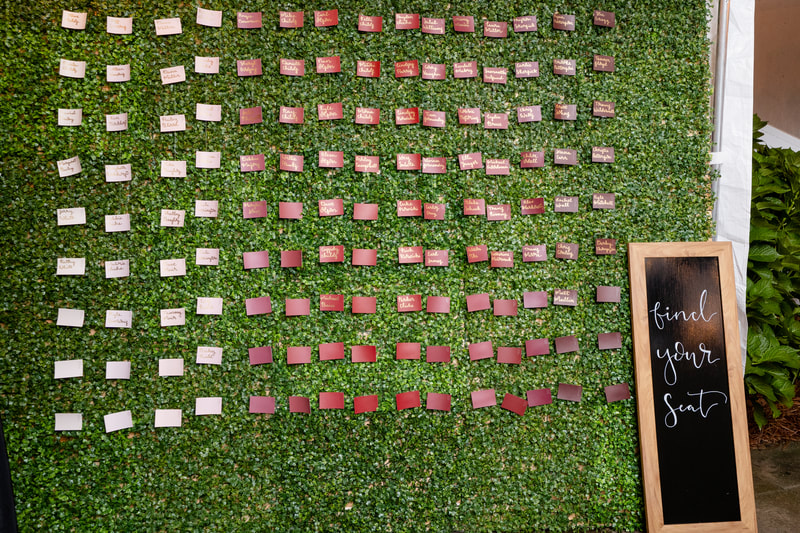 greenery wall and paint chips seating chart