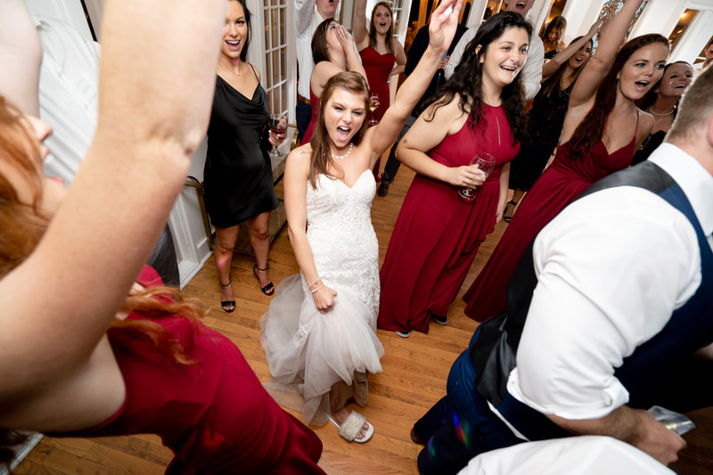 bride and bridesmaids dancing in carriage house