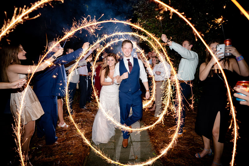 newlyweds during sparkler grand exit with sparkler edit effect by photographer