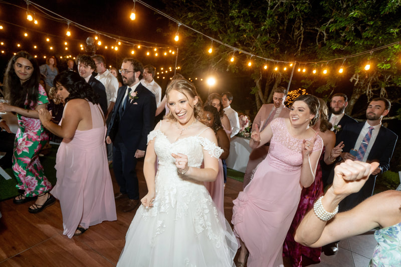bride dancing in outdoor dance floor with guests