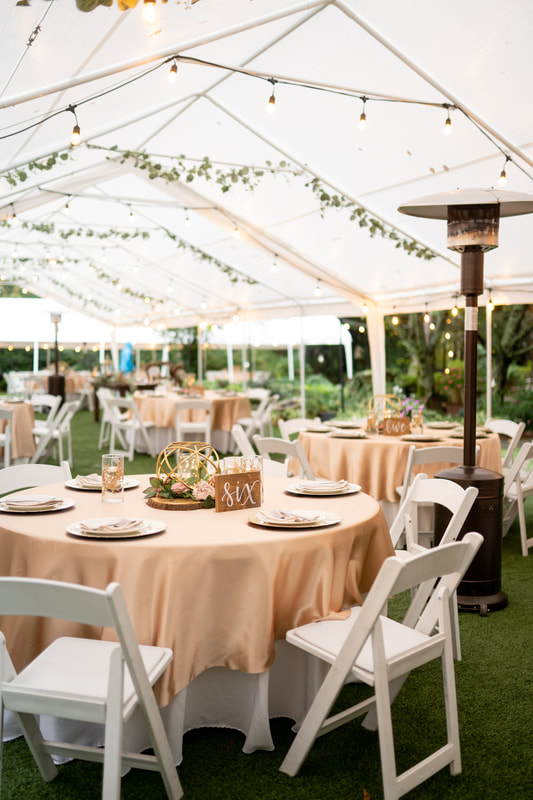 tented garden reception tables with champagne overlays